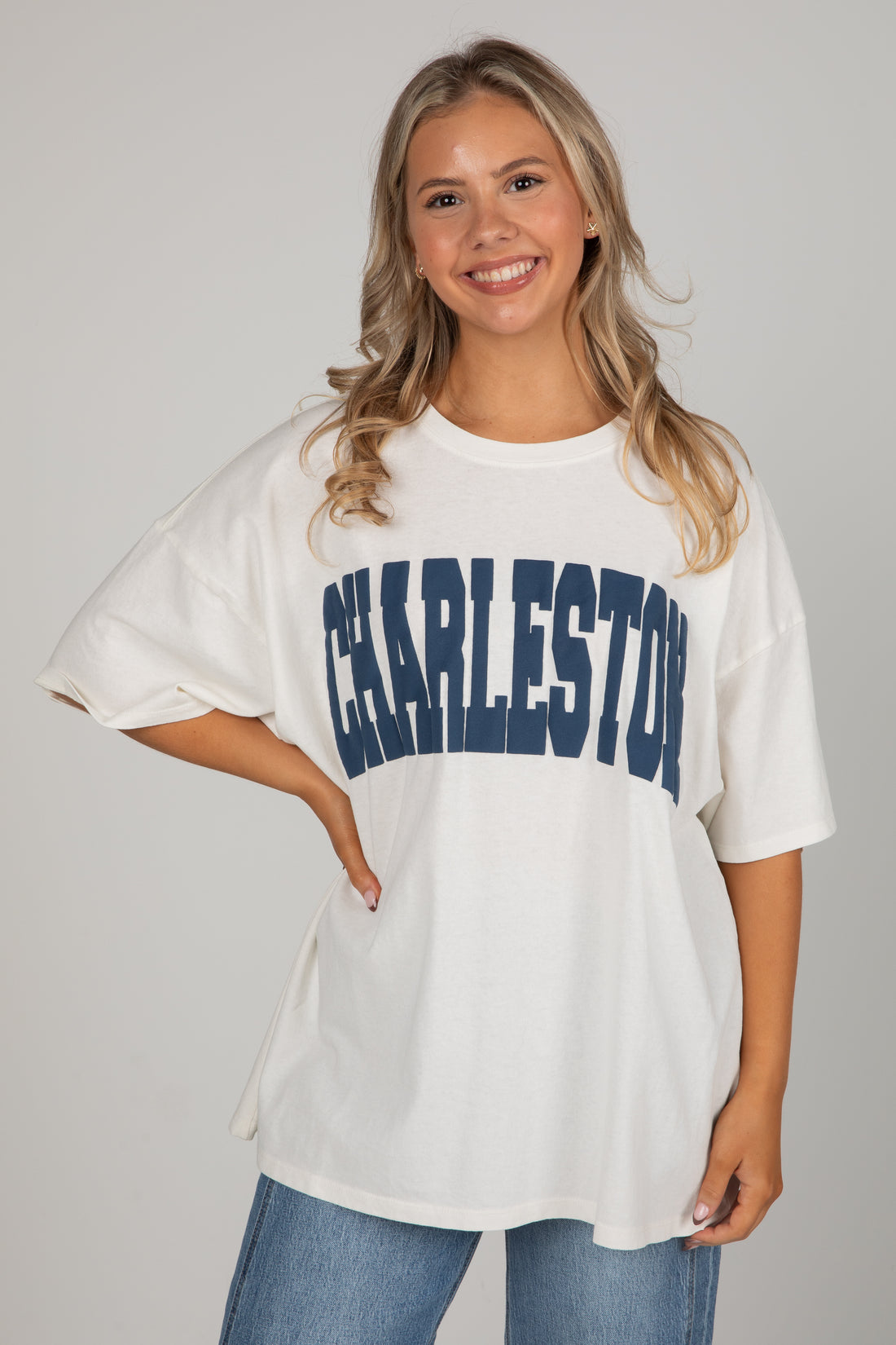 Woman wearing a white oversized t-shirt with &