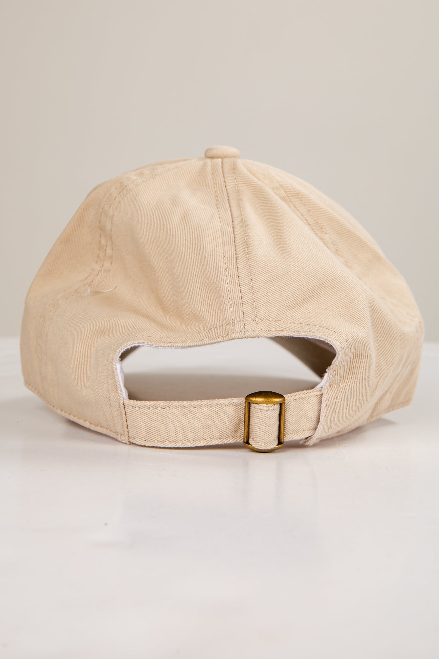 Beige baseball cap on a light gray background