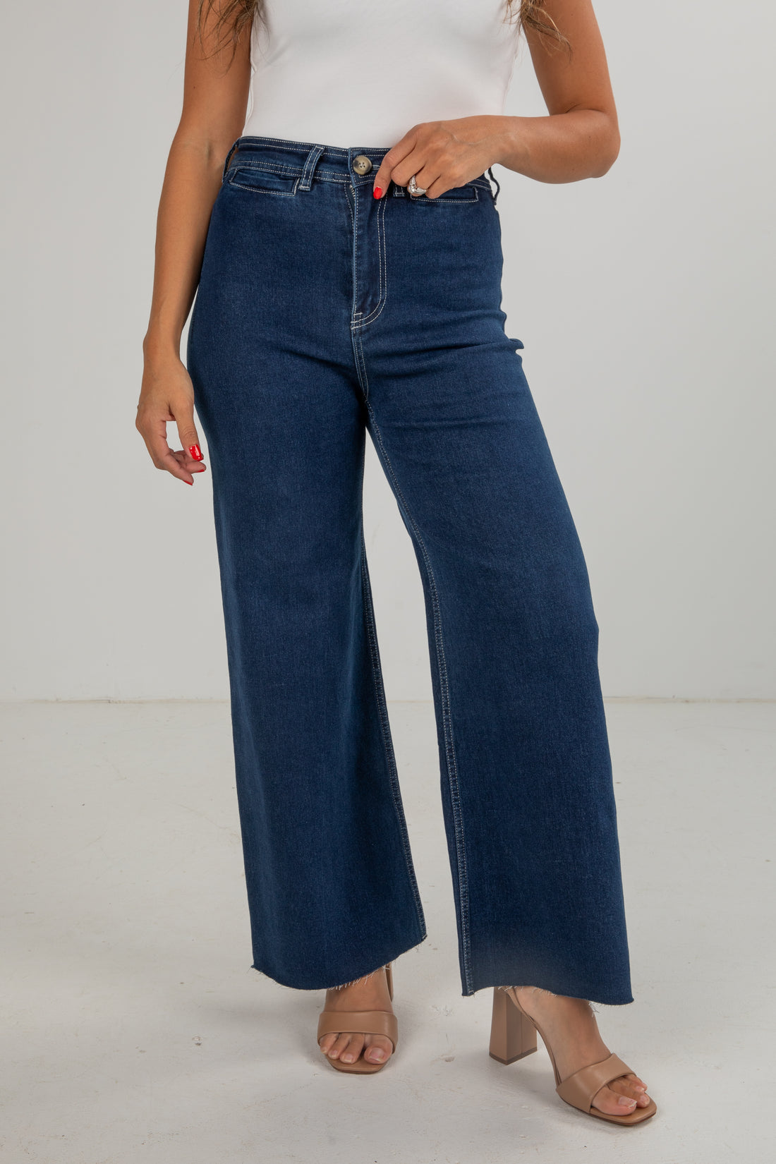 Person wearing blue wide-leg jeans on a white background