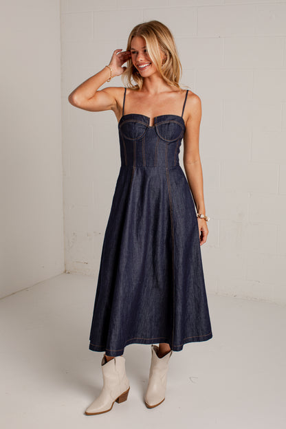 dark-wash midi dress features a strapless bustier-inspired bodice with defined seaming and a flattering fitted silhouette