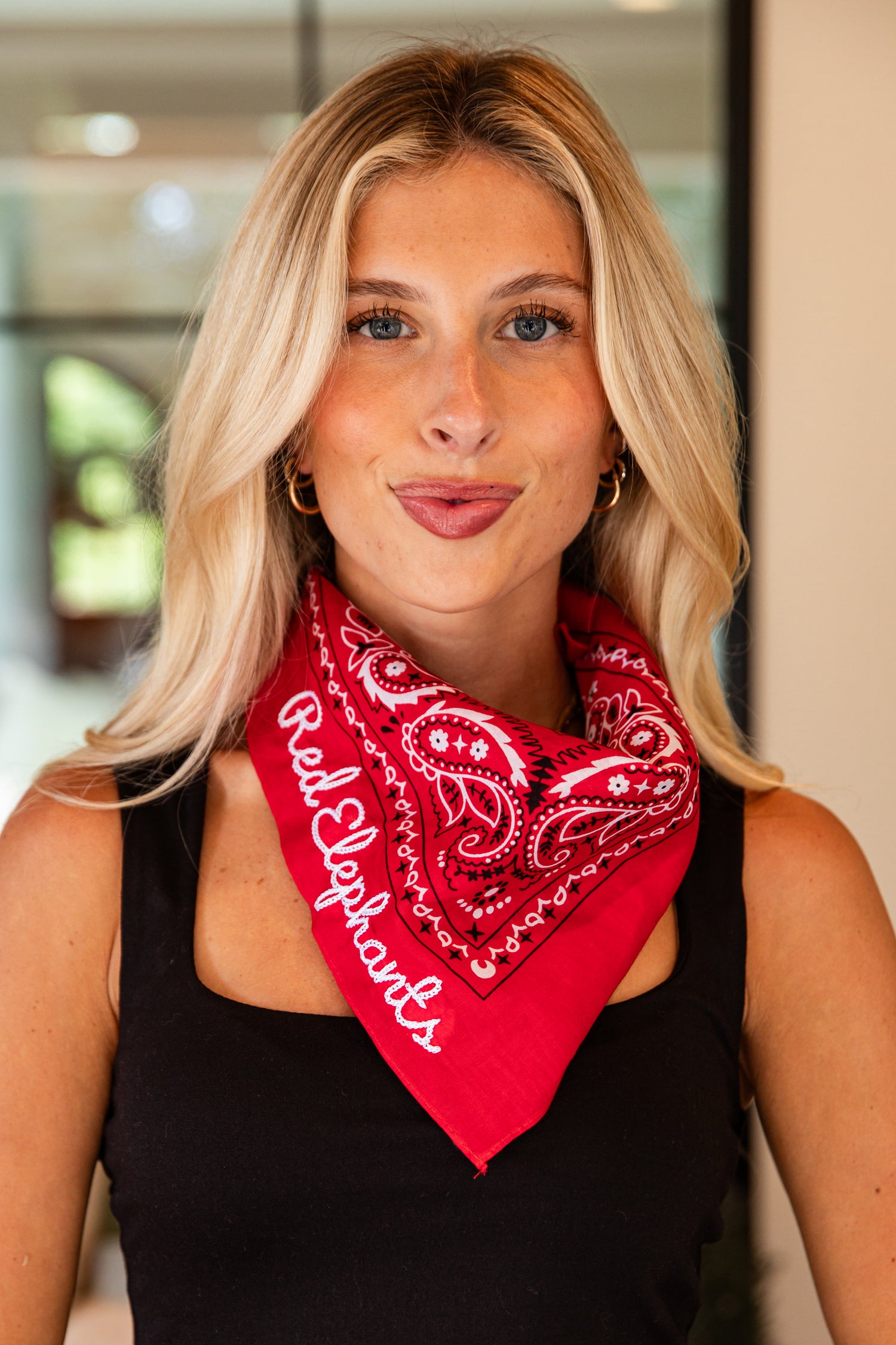 Woman wearing a red bandana with &