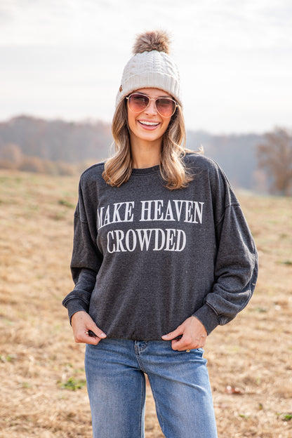 Woman wearing a dark gray sweatshirt with &