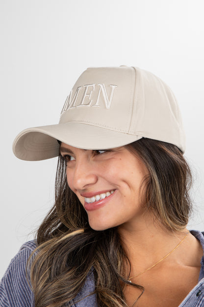 Woman wearing a beige cap with &
