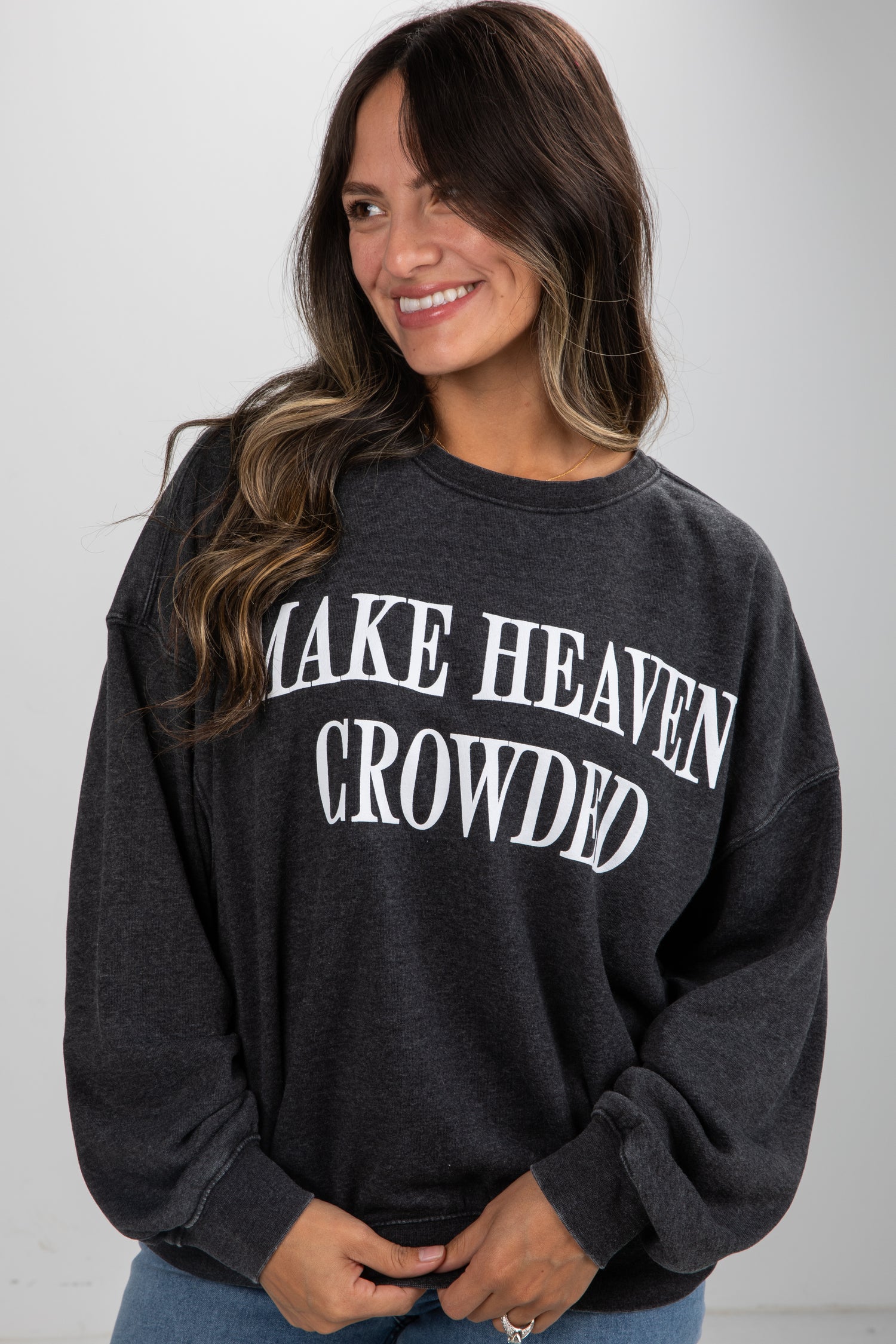 Woman wearing a black sweatshirt with &