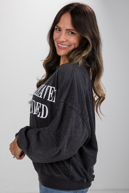 Woman wearing a dark gray sweatshirt with text on a white background