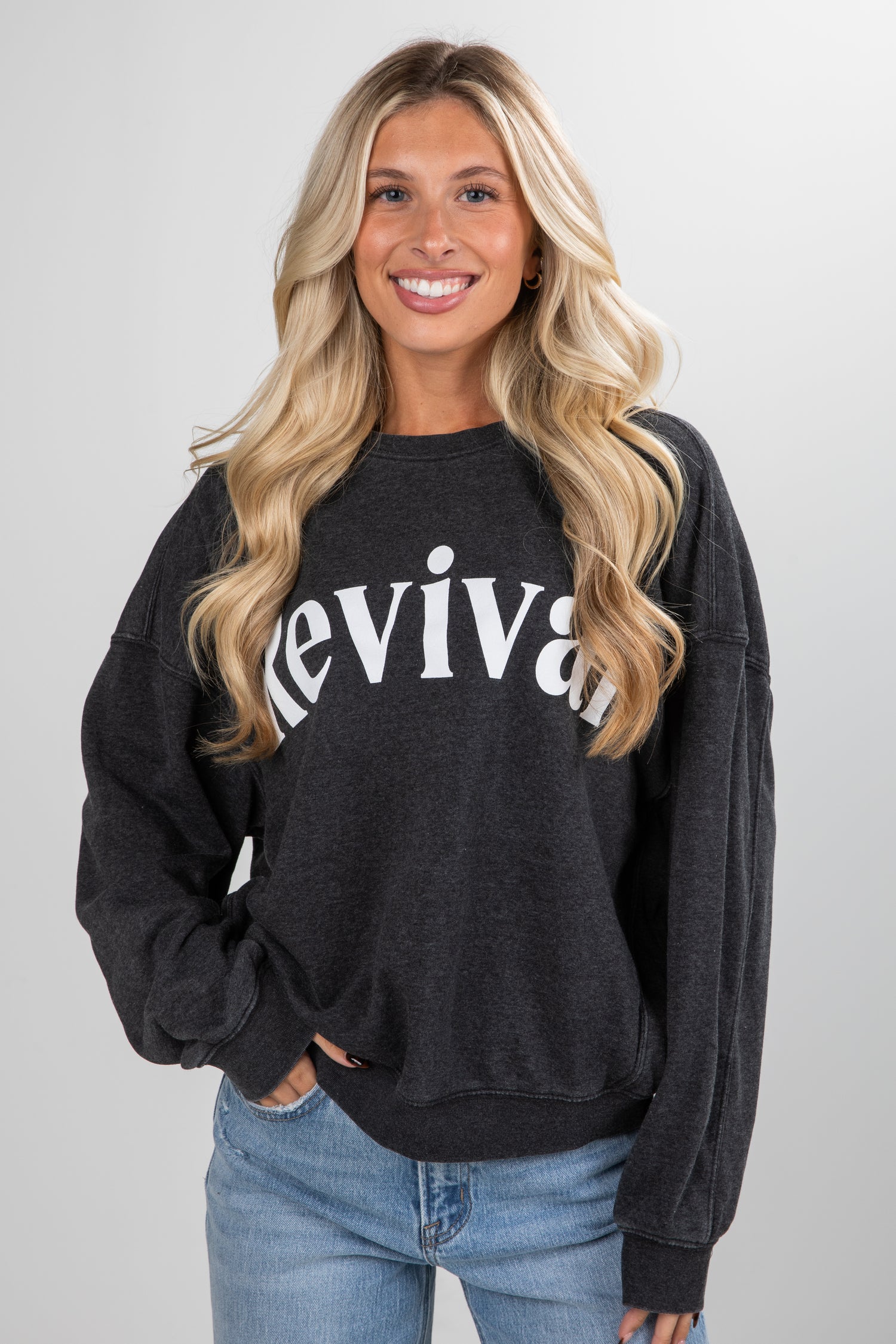 Woman wearing a black sweatshirt with &