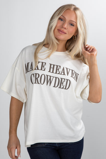 Woman wearing a white t-shirt with text on a plain background