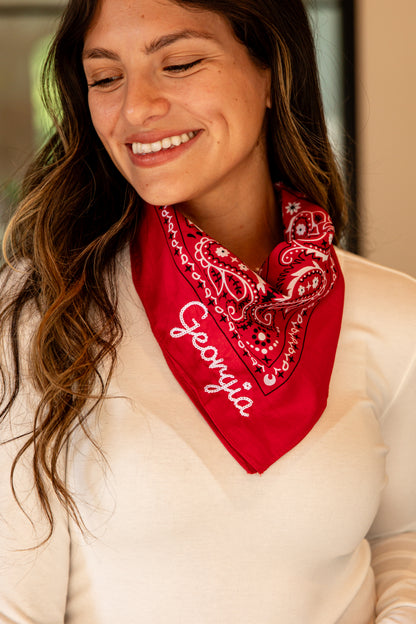 Woman wearing a red bandana with &