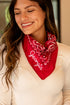 Woman wearing a red bandana with &