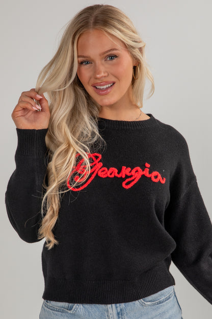 Woman wearing a black sweater with &