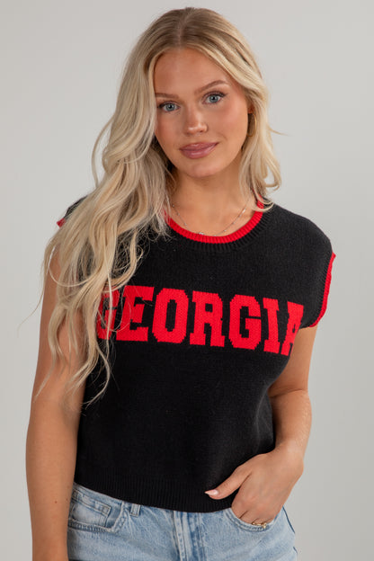 Woman wearing a black sleeveless top with &