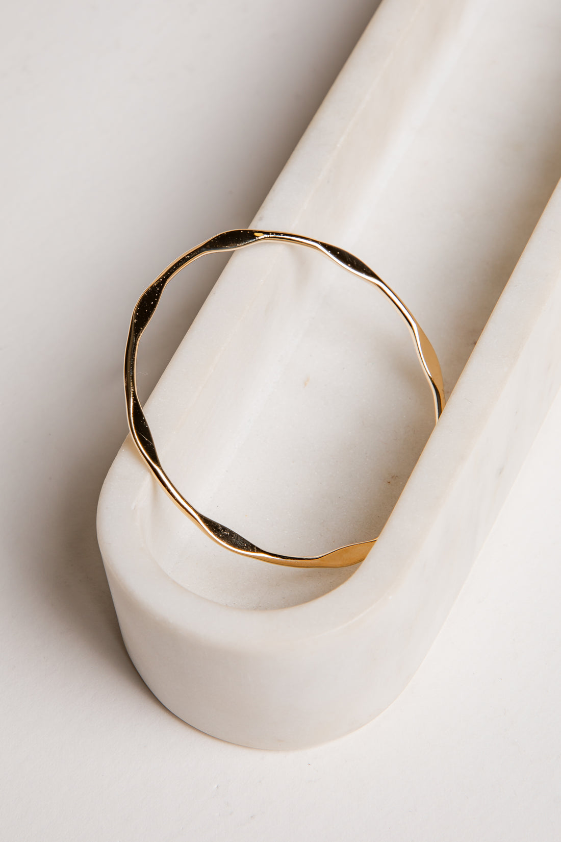 Gold ring on a white ceramic object