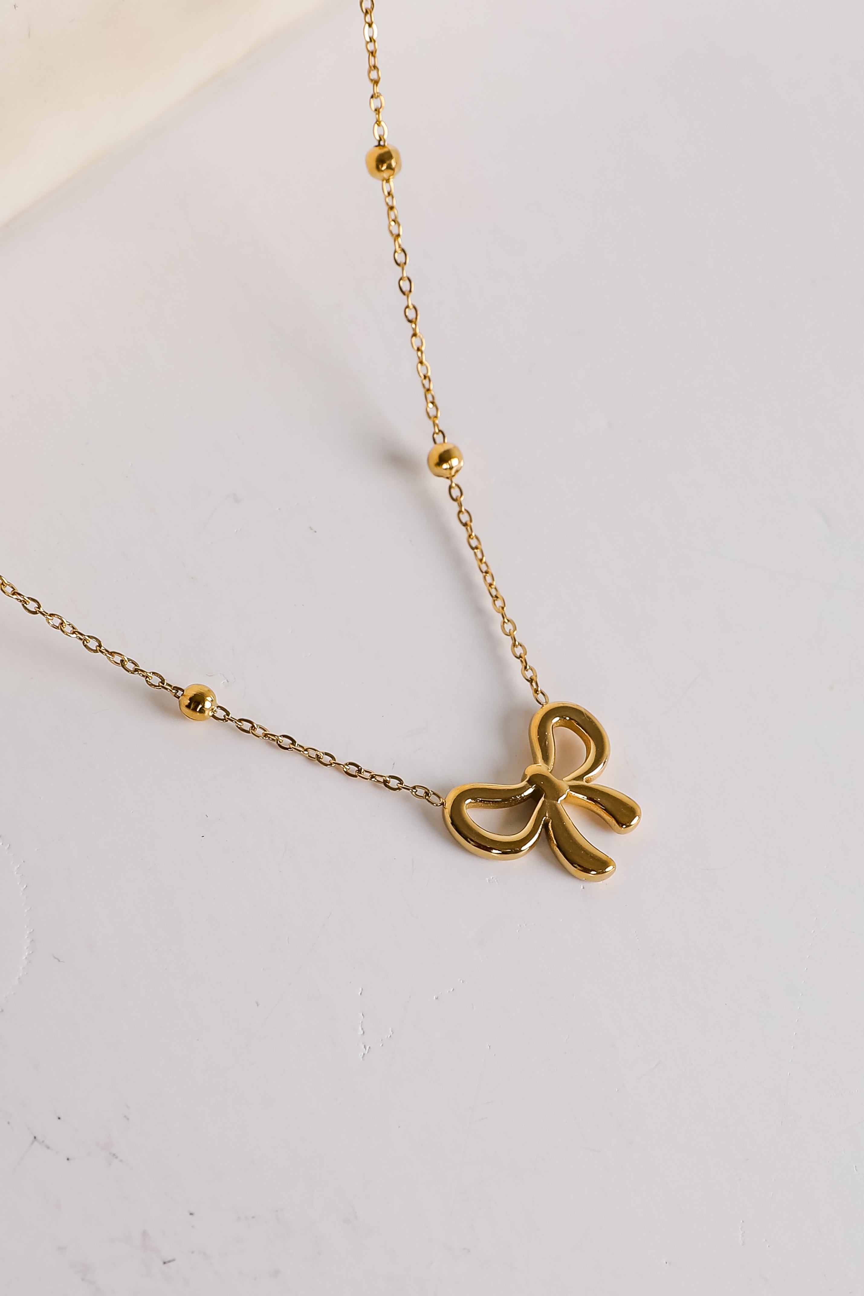 Elizabeth Gold Bow Charm Necklace