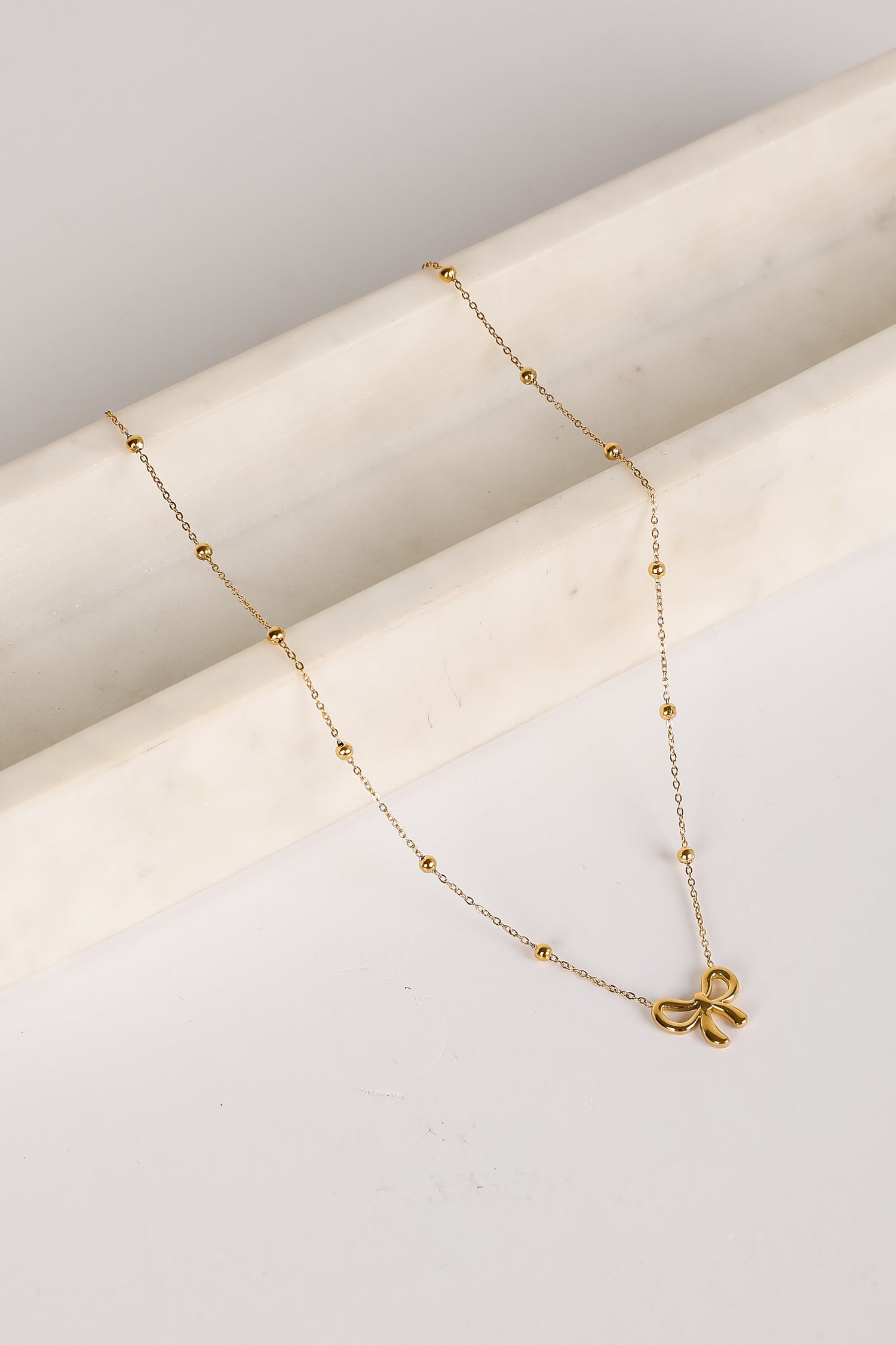 Elizabeth Gold Bow Charm Necklace