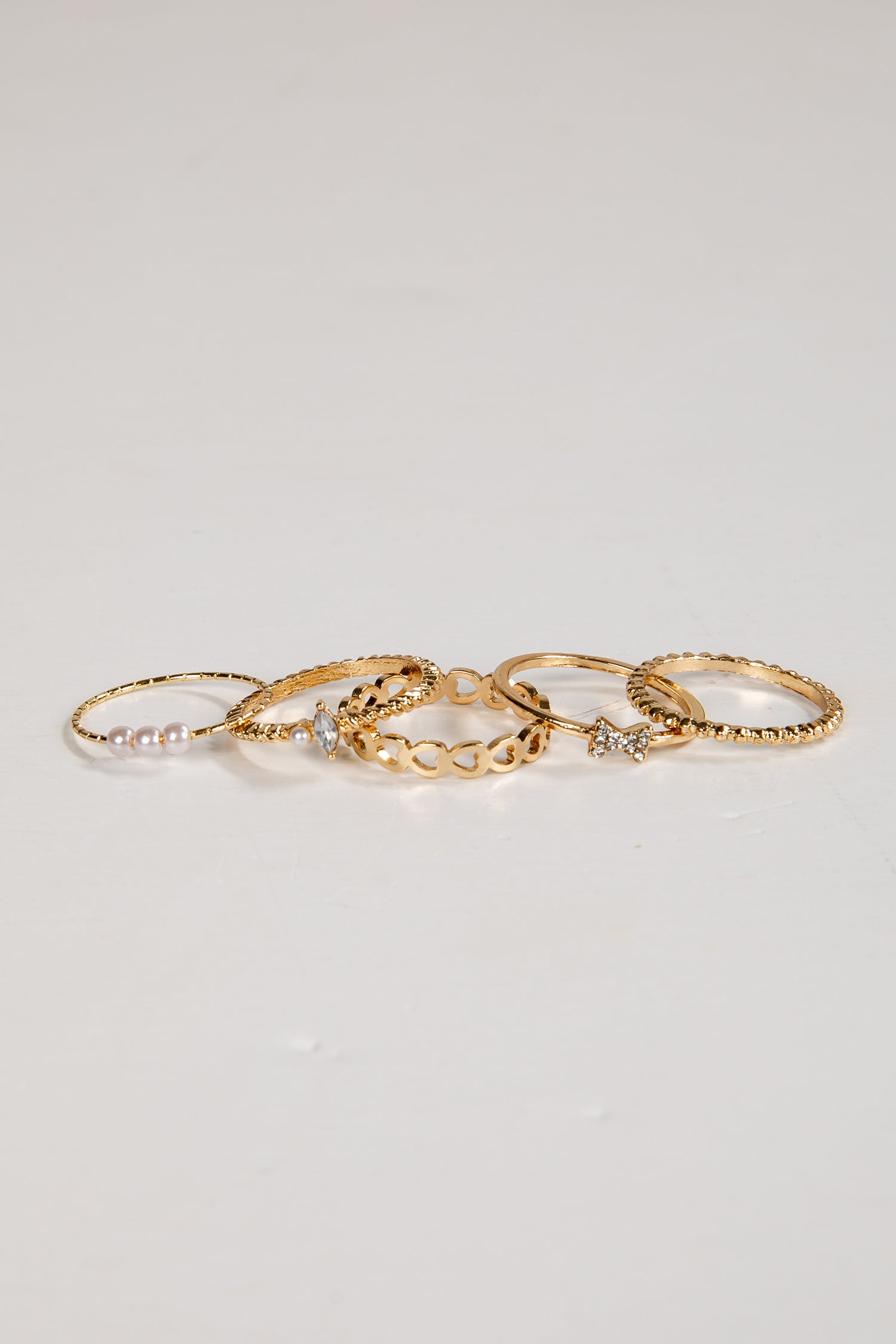 Set of gold rings on a light gray background