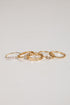 Set of gold rings on a light gray background