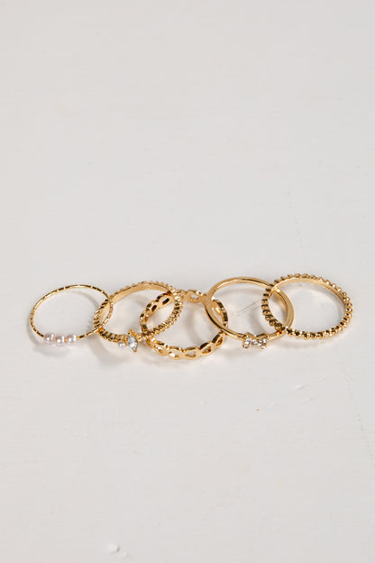 Set of gold rings on a light gray background
