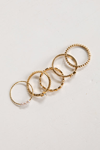 Set of gold rings on a light gray background
