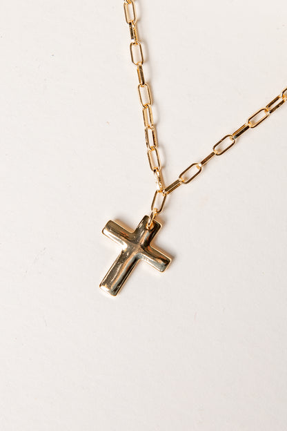 Gold chain necklace with a cross pendant on a white background