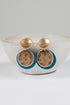 Pair of earrings with gold and blue components on a white background
