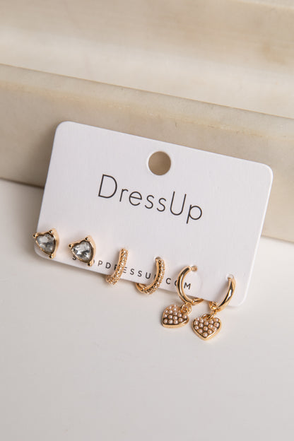 Set of gold earrings on a &