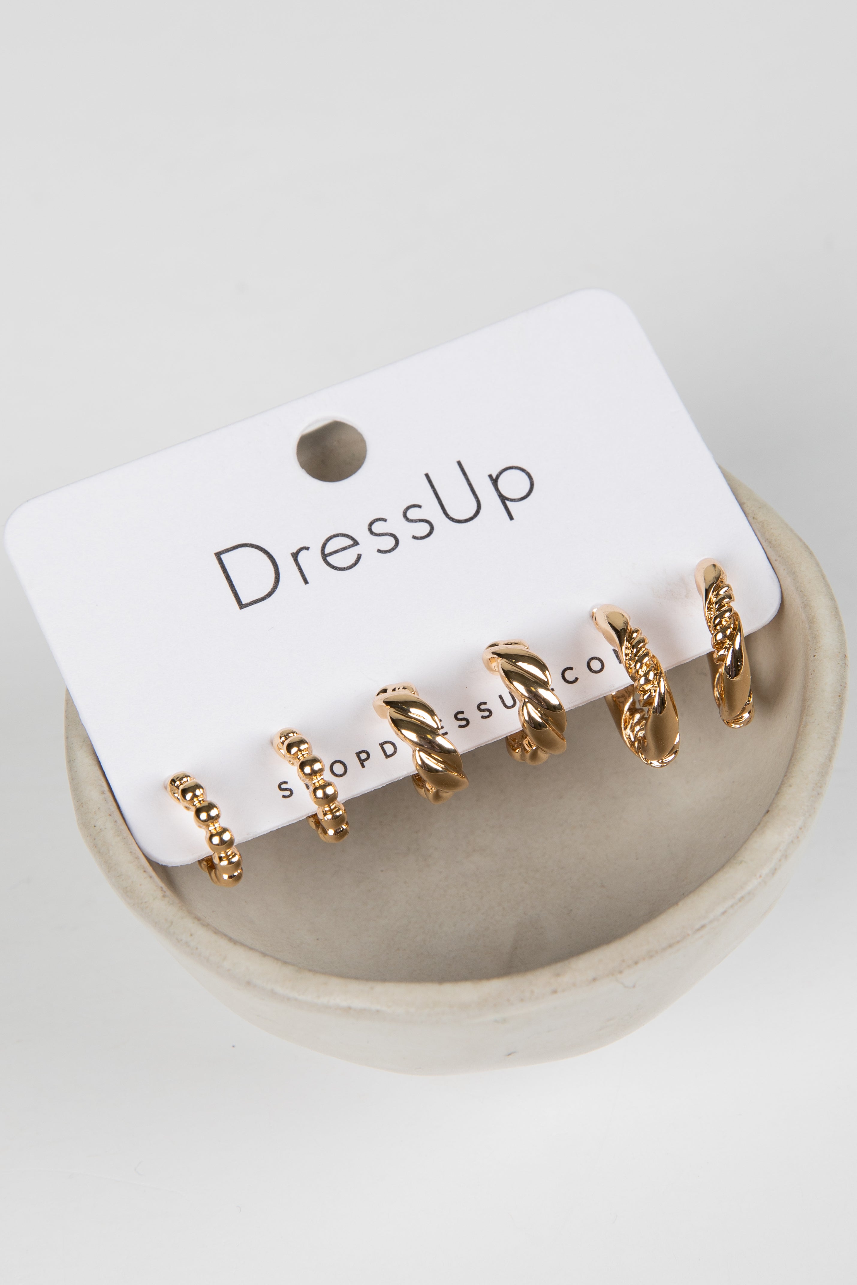 Gold hoop earrings on a &