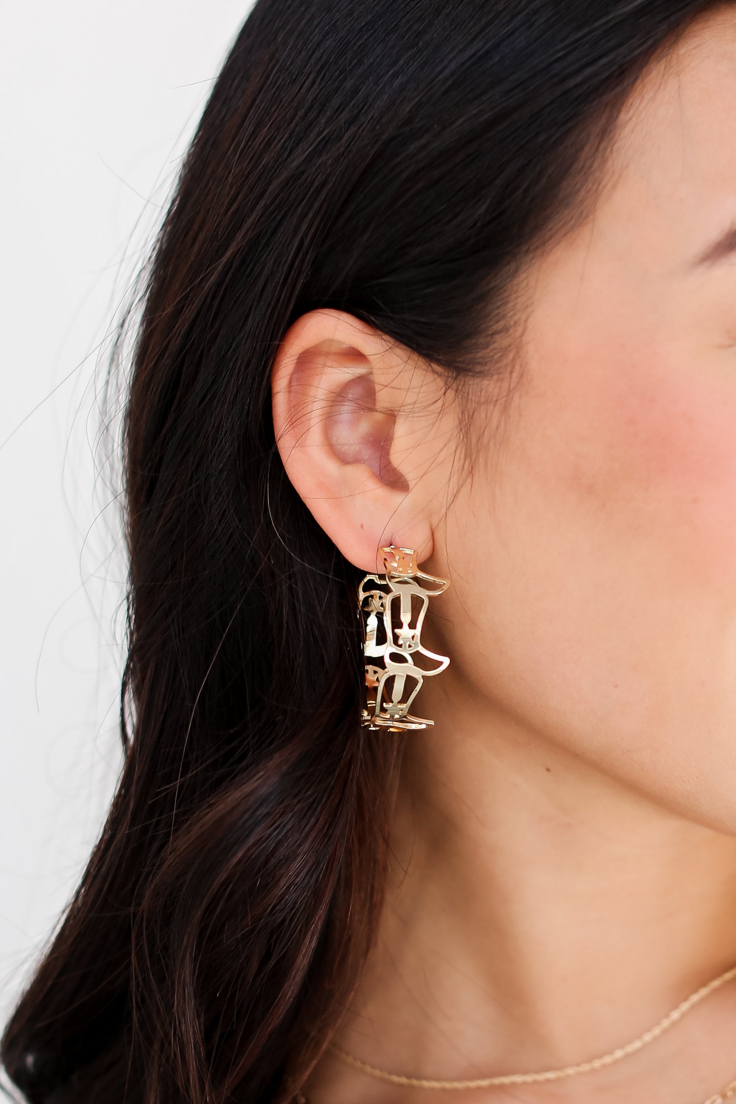 Gold Cowboy Boot Hoop Earrings on dress up model