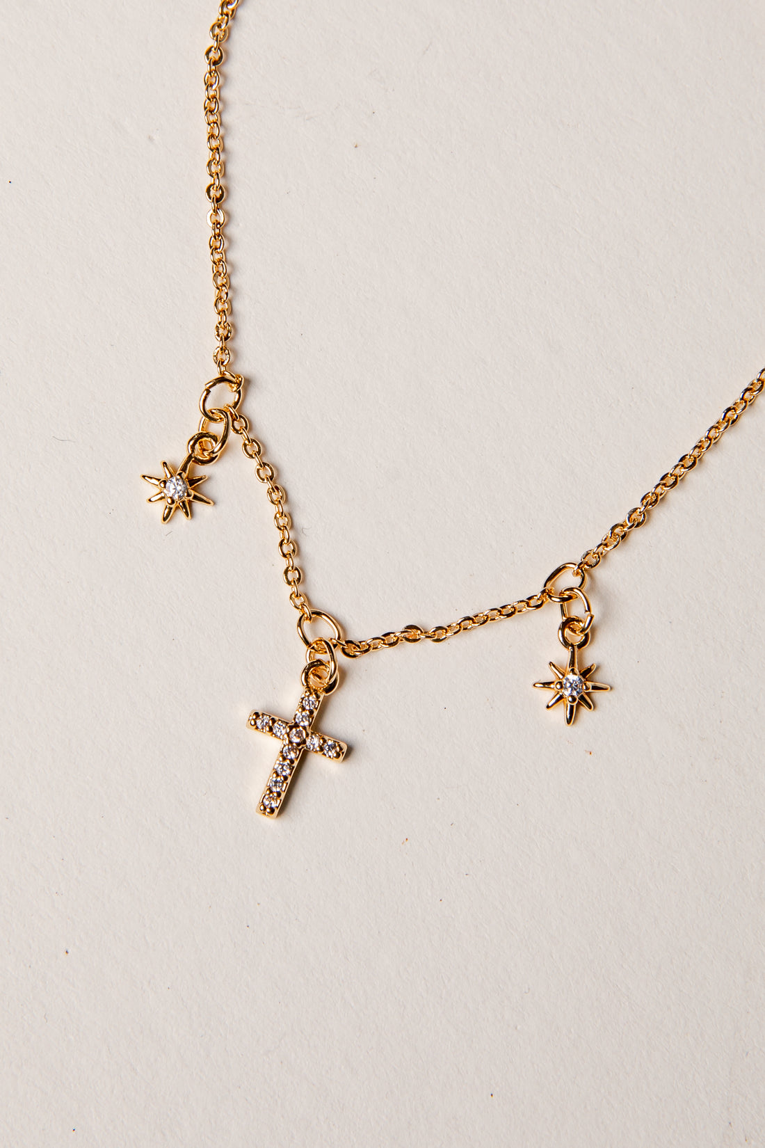 Gold Necklace against plain background