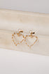 Gold heart-shaped earrings on a light wooden surface