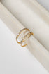 Gold earrings with embedded stones on a white surface
