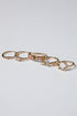 Set of gold rings with gemstones on a light gray background