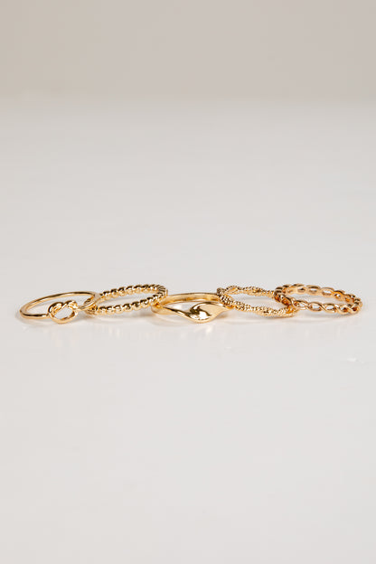 Set of gold rings on a light gray background