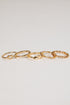 Set of gold chain rings on a light gray background