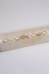 Set of gold rings on a marble surface with a light background
