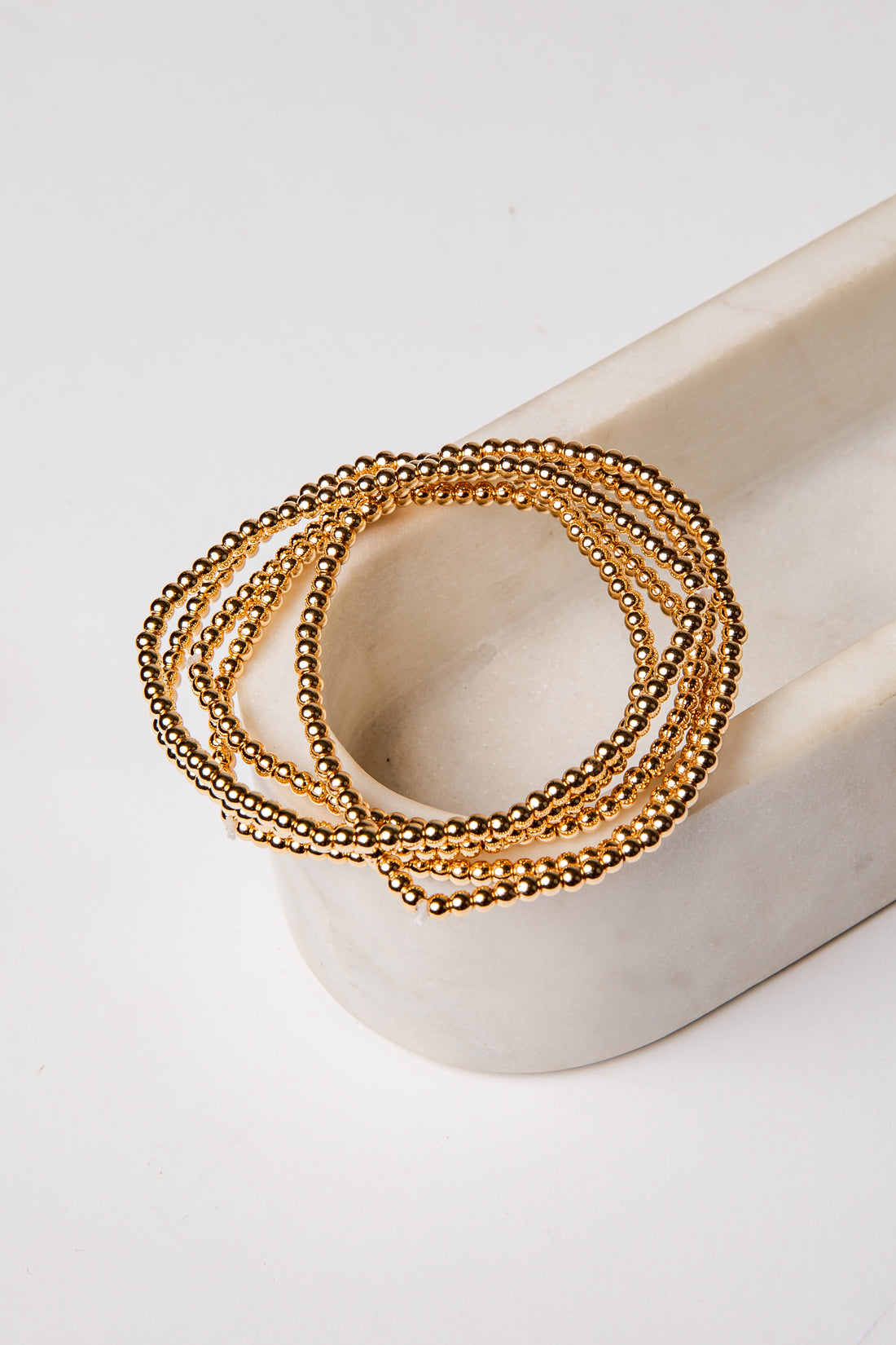 set of 5 gold beaded bracelets