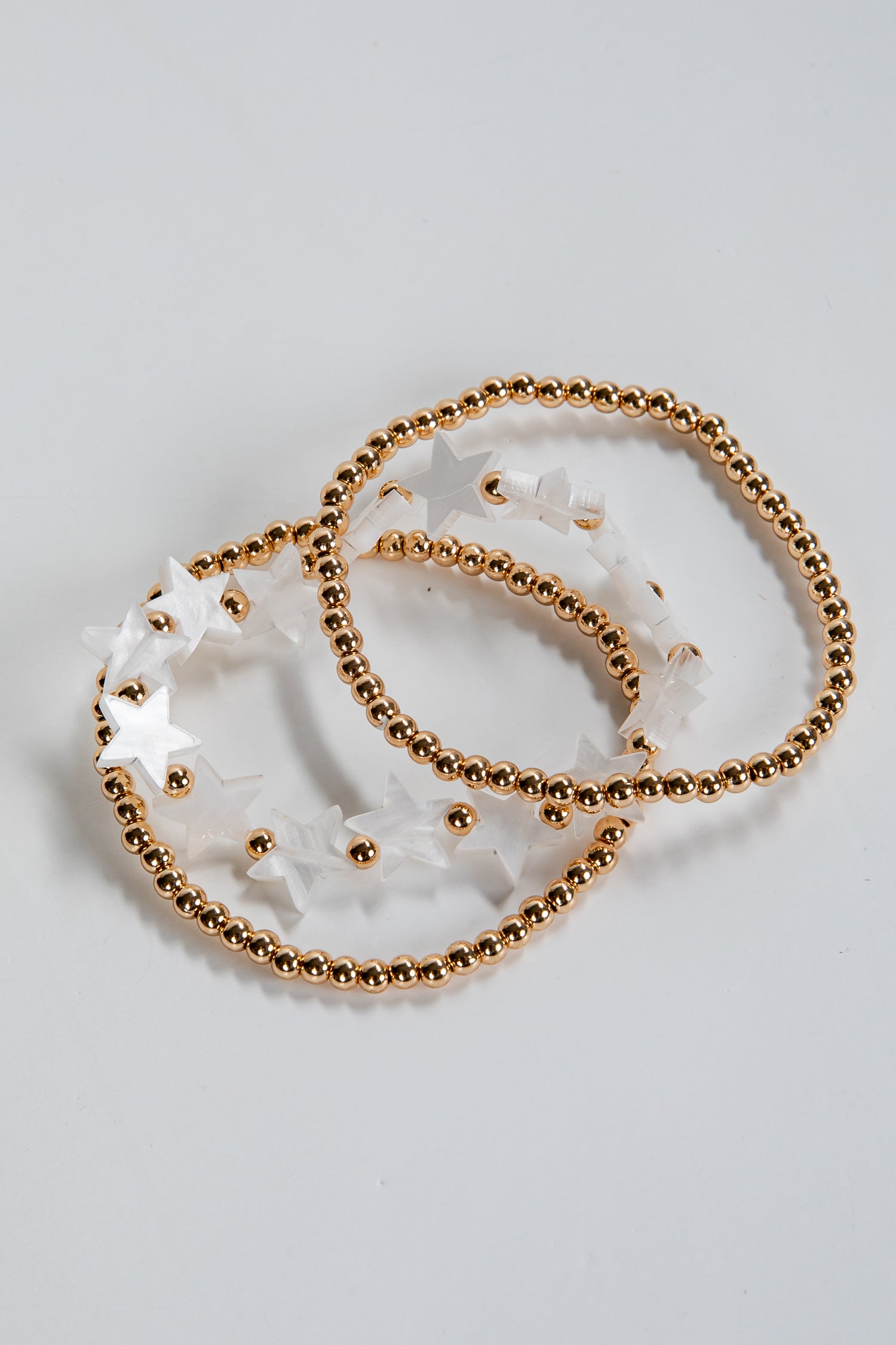 Gold beaded bracelet on a white surface