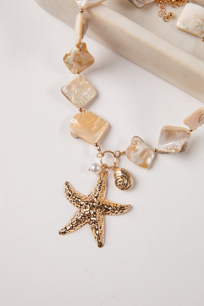 Necklace with starfish pendant and shell beads on a white background