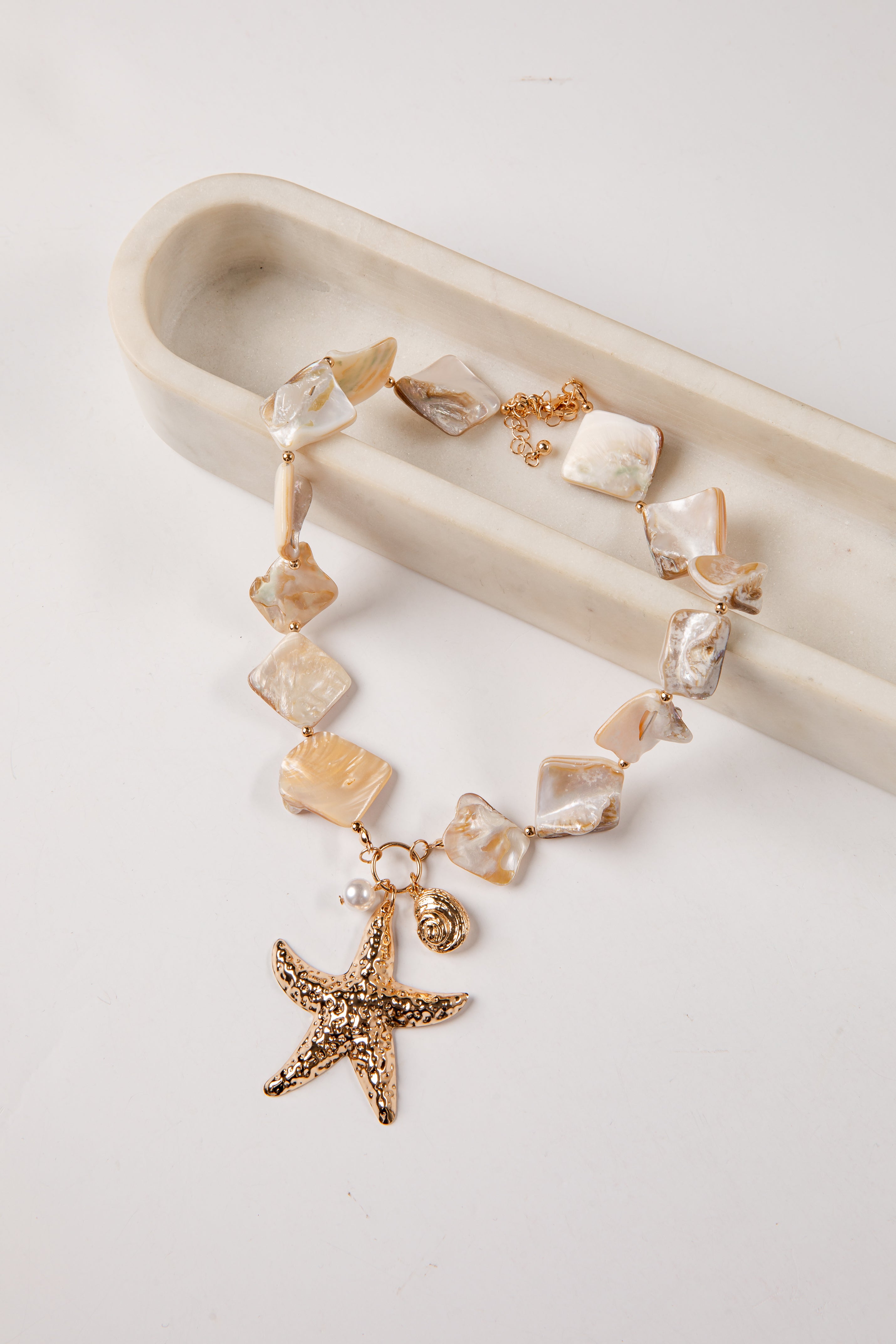 necklace with starfish charm on a white background