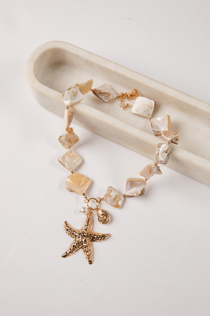 necklace with starfish charm on a white background