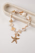 necklace with starfish charm and crystal-like beads on a white background