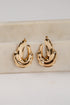 Gold hoop earrings on a marble surface
