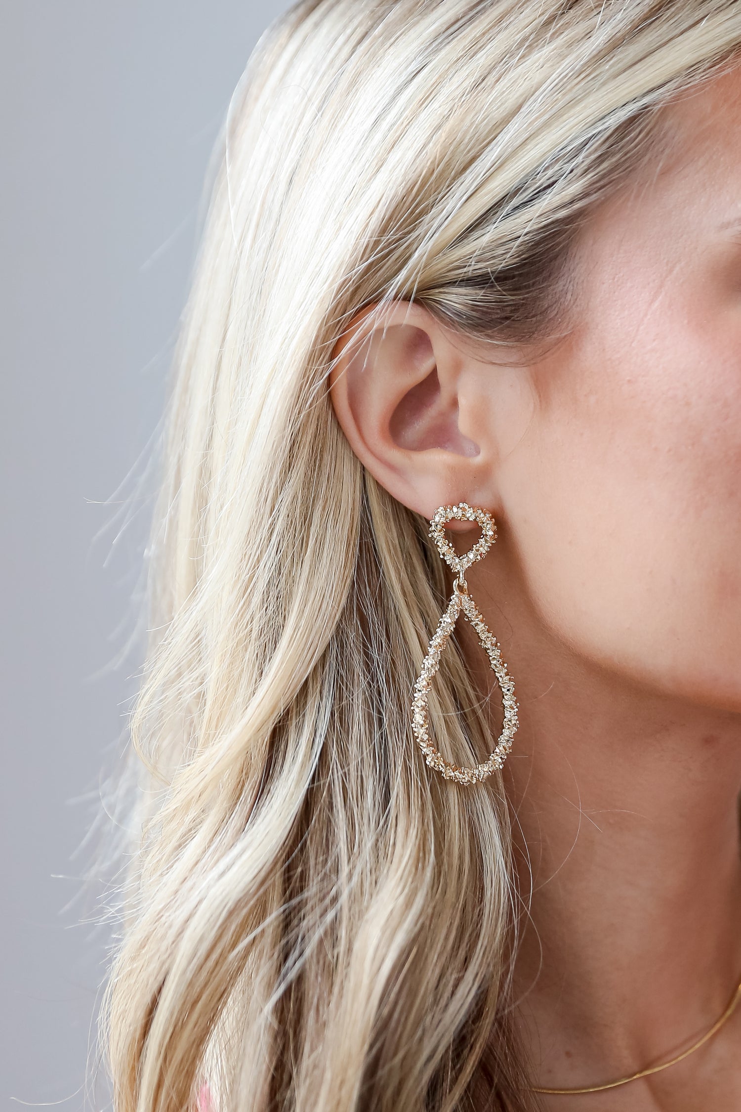 Gold Textured Drop Teardrop Earrings on model