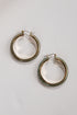 Pair of gold hoop earrings on a light gray background