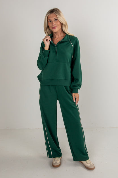 Woman wearing a green tracksuit on a white background