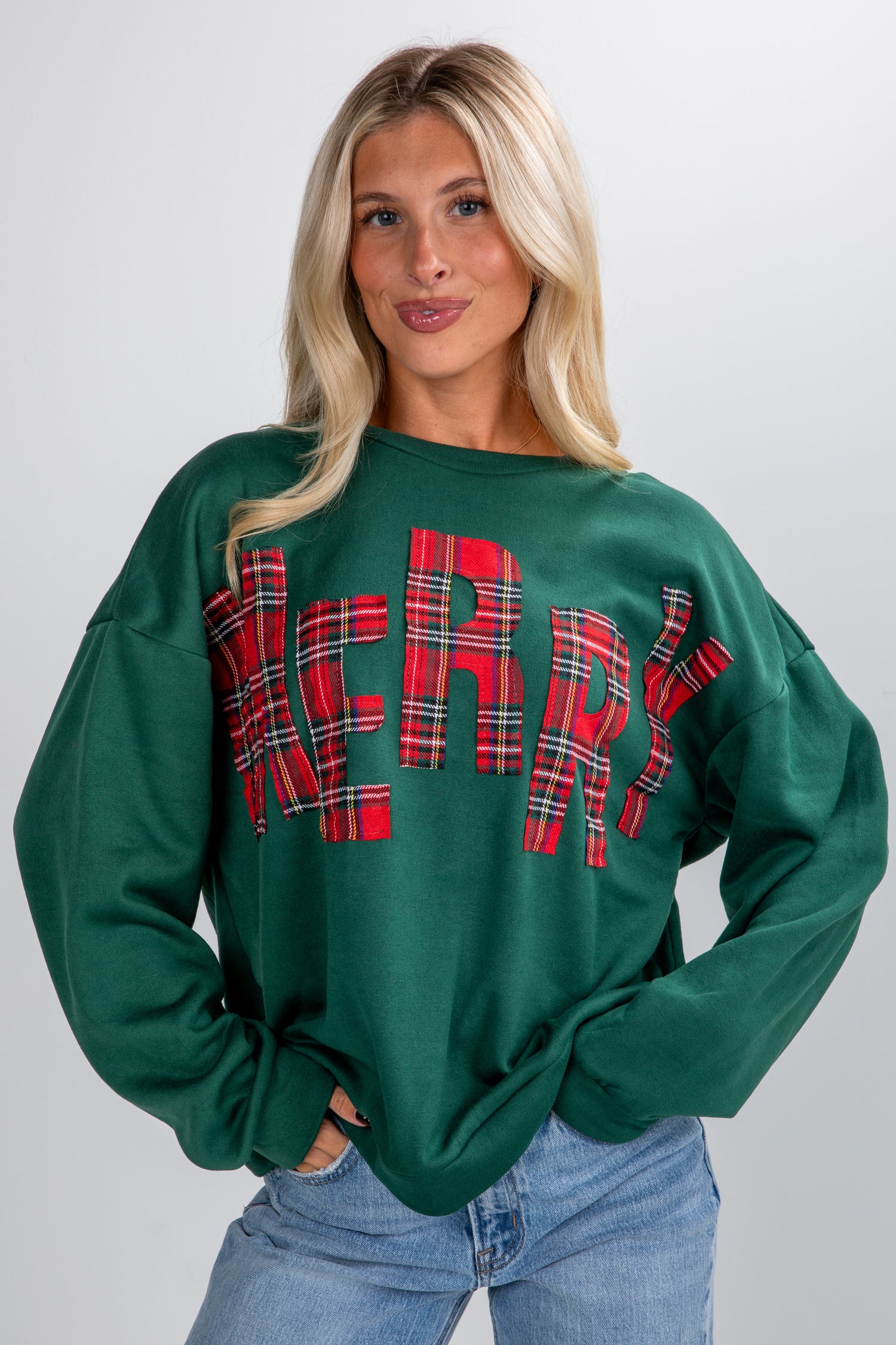 Woman wearing a green sweatshirt with &