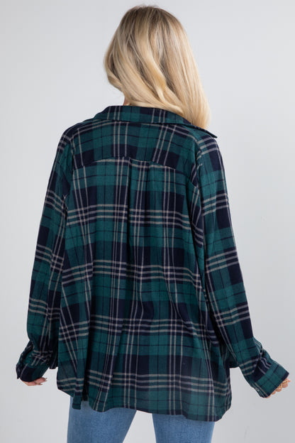 Person wearing a green and black plaid shirt on a white background