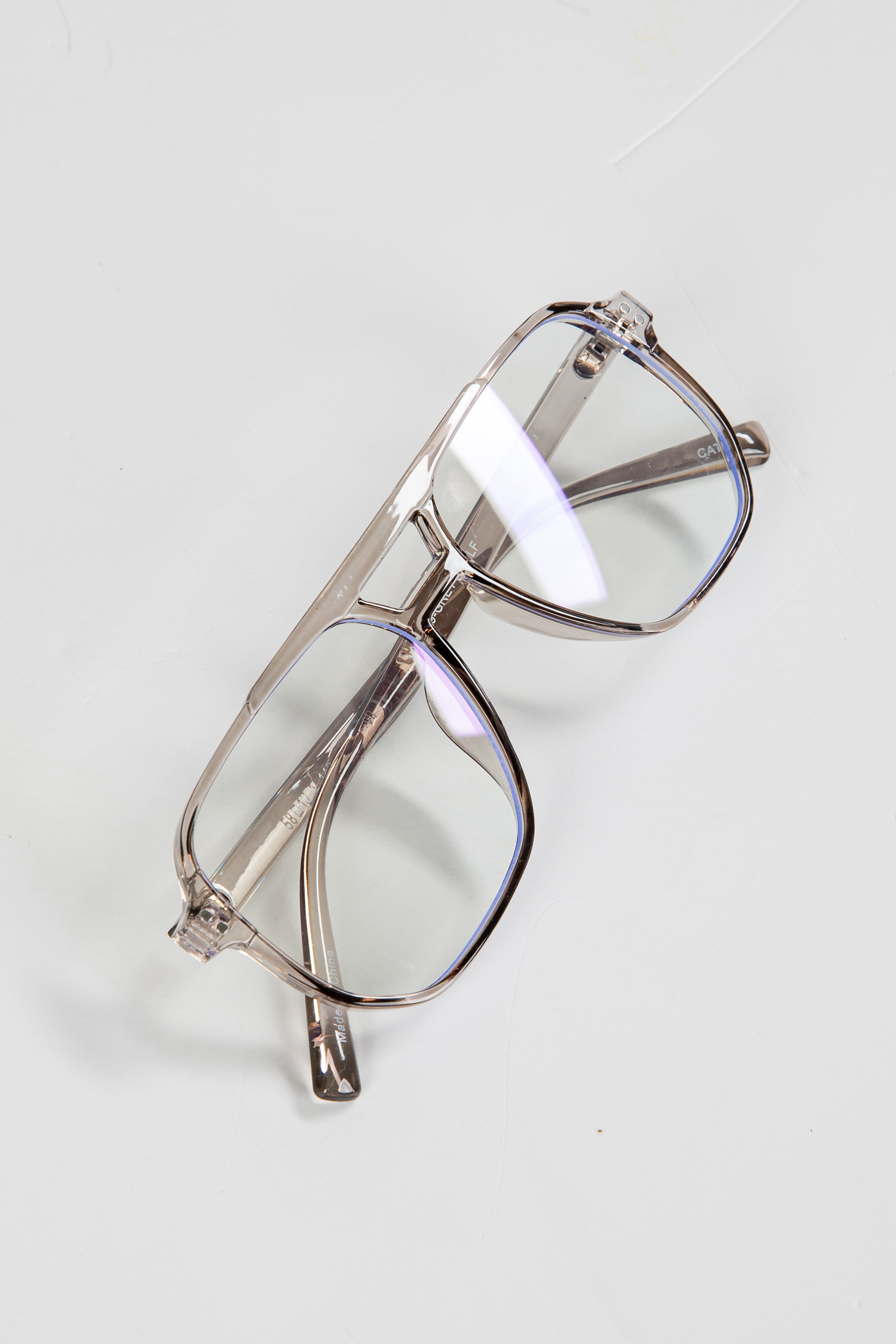 Clear eyeglasses on a light gray background