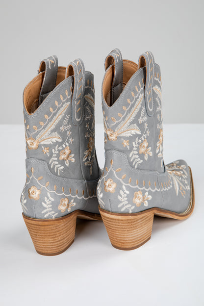 Gray cowboy boots with floral embroidery on a white background