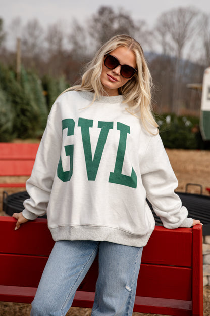 Person wearing a white sweatshirt with &