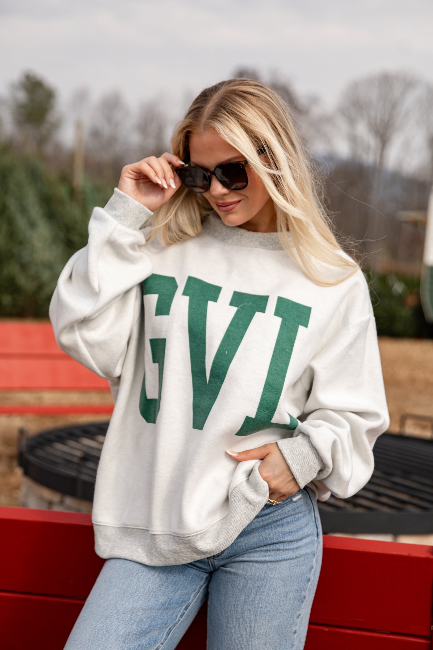 Woman wearing a white sweatshirt with &